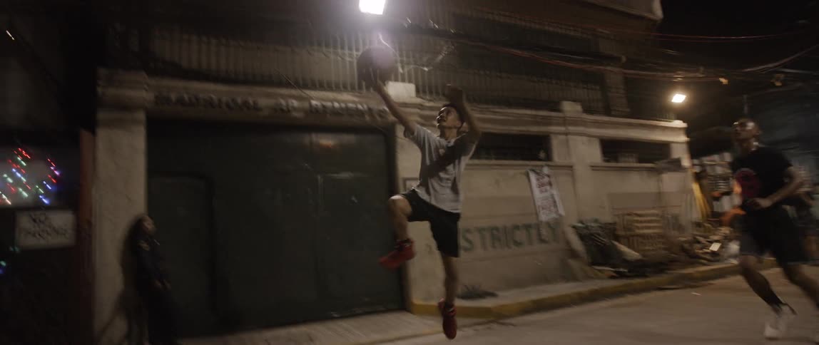 A group of young men playing basketball in the city