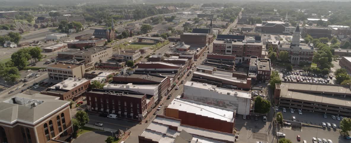 Aerial footage of a small town with buildings and green space