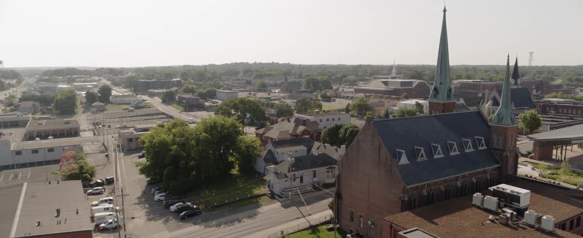 A church with steeples sits in the middle of a town