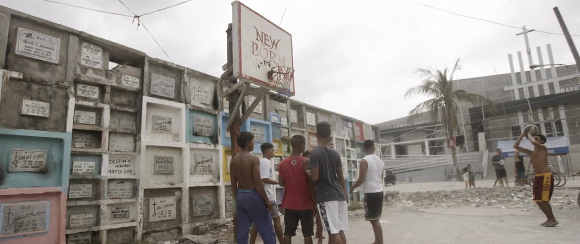 Children are playing basketball in the lot