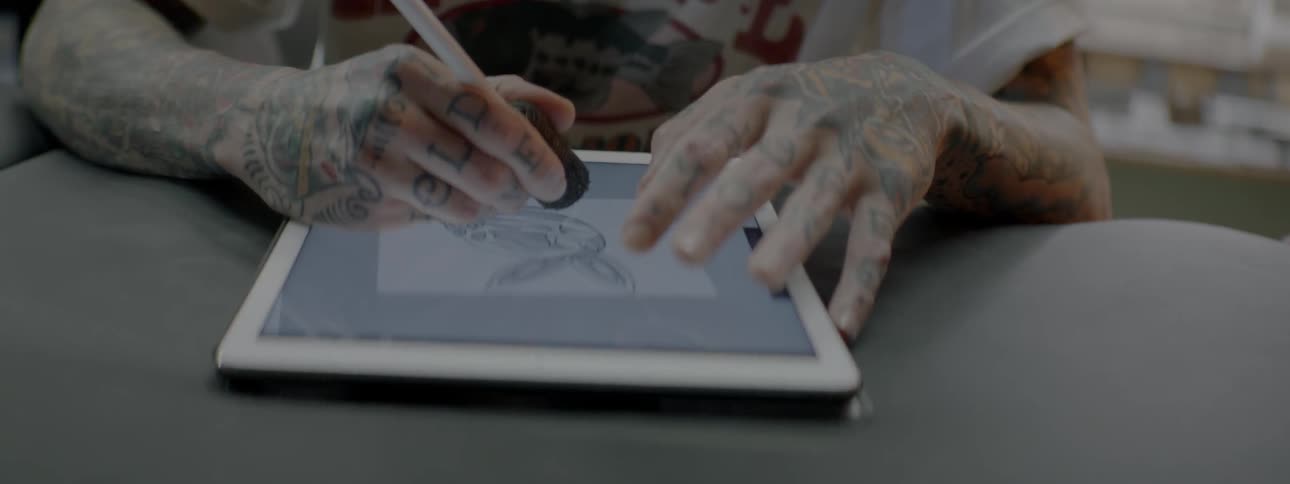 A man is drawing on a tablet in the store
