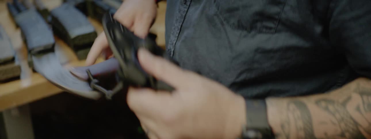 A man with a table full of knives and weapons