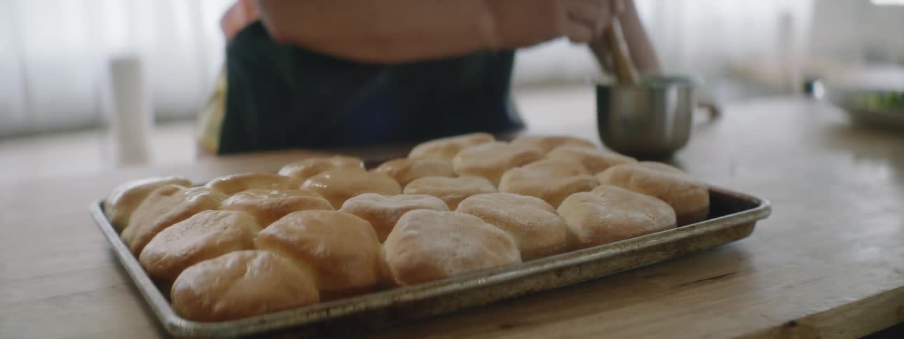 A person buttering rolls