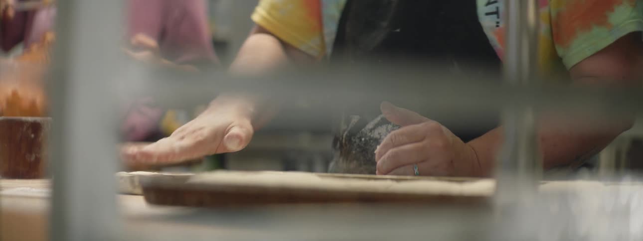 People are working in the restaurant with dough