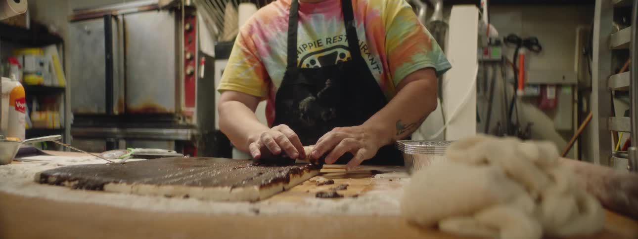 A person is preparing pastries in a kitchen