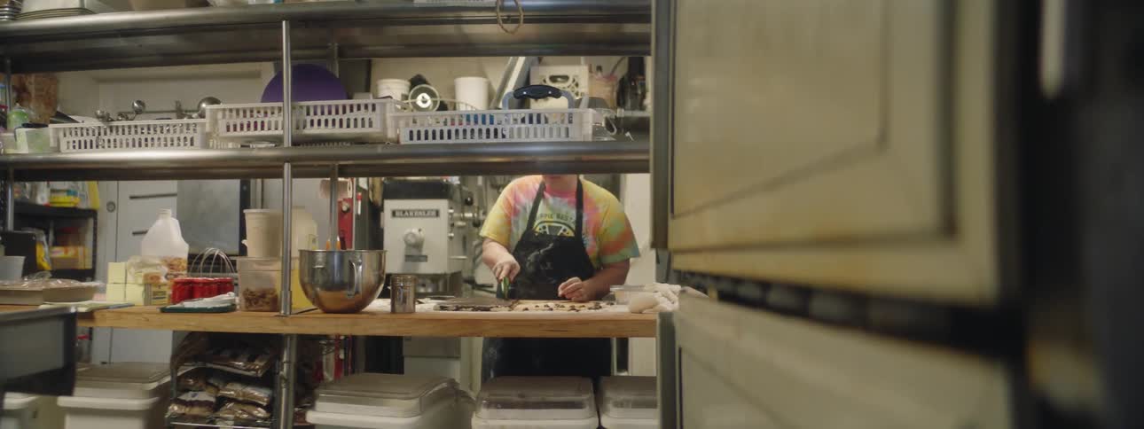 Person cuts dough in restaurant kitchen