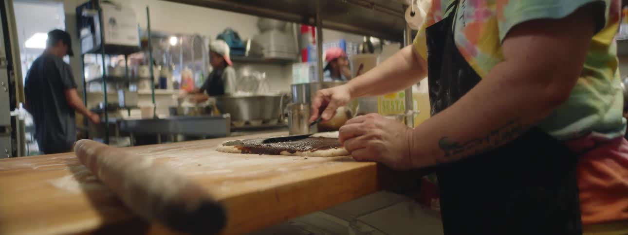 People are preparing food in a restaurant kitchen