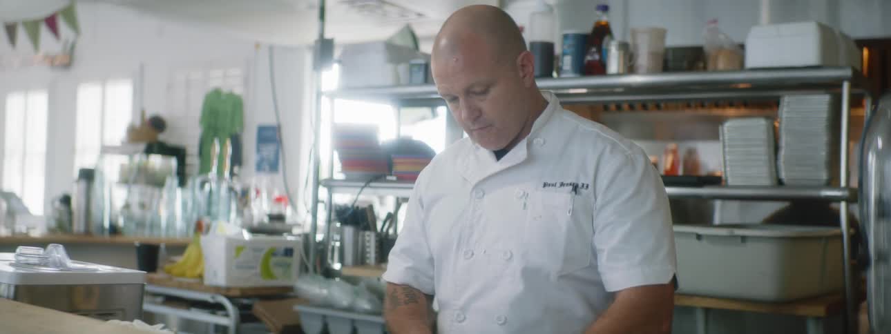 A chef works in a commercial kitchen