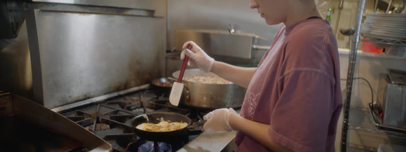 A woman working in a kitchen at a restaurant