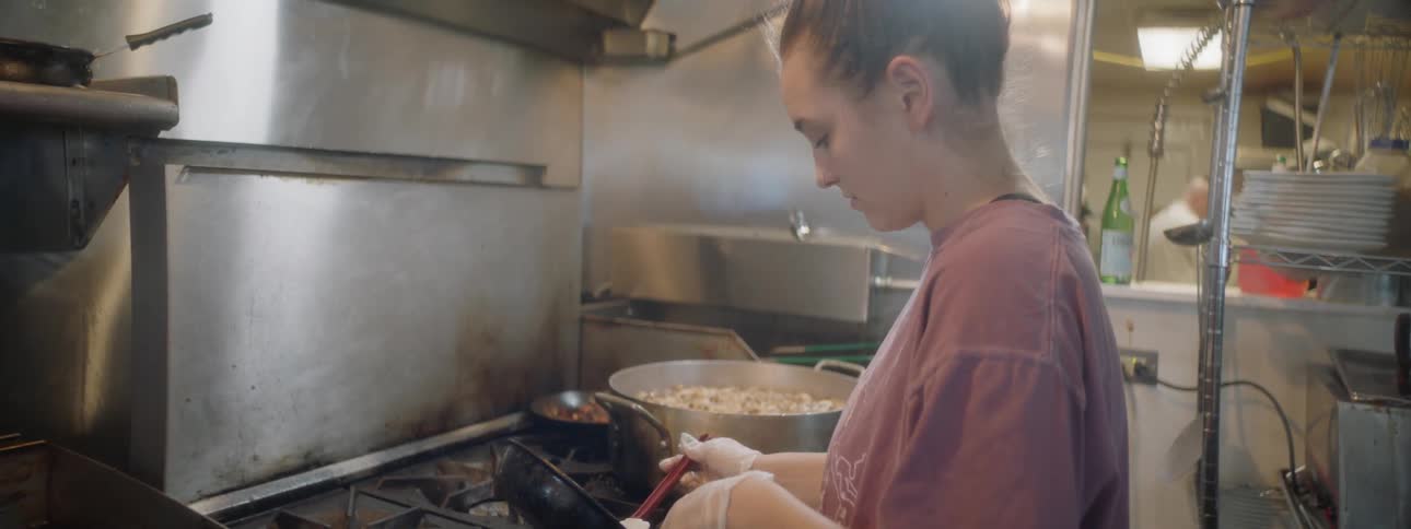 A woman working in a kitchen in a restaurant