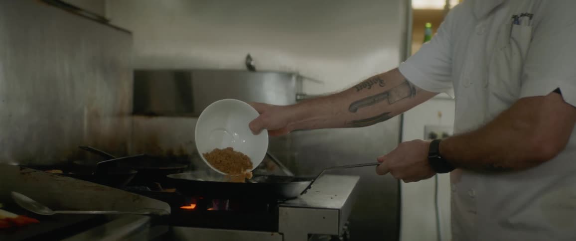 A man is cooking at a stove