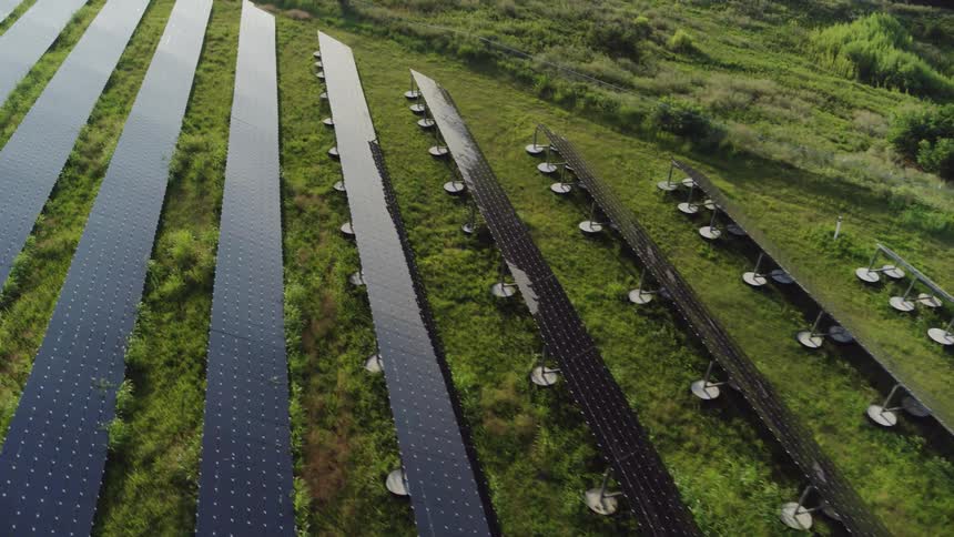 Flying over solar panels in a field