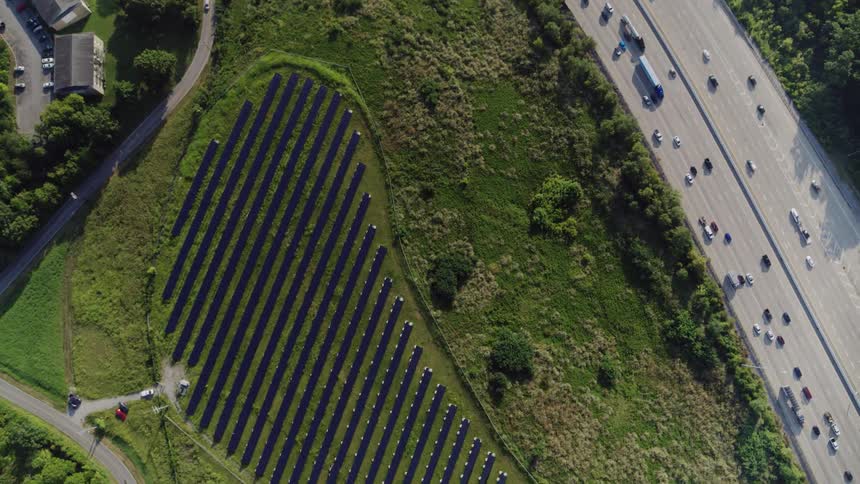 Birds eye view of a highway and a solar farm