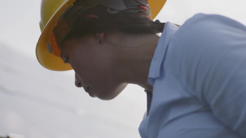 Female inspector inspecting panels on a job site