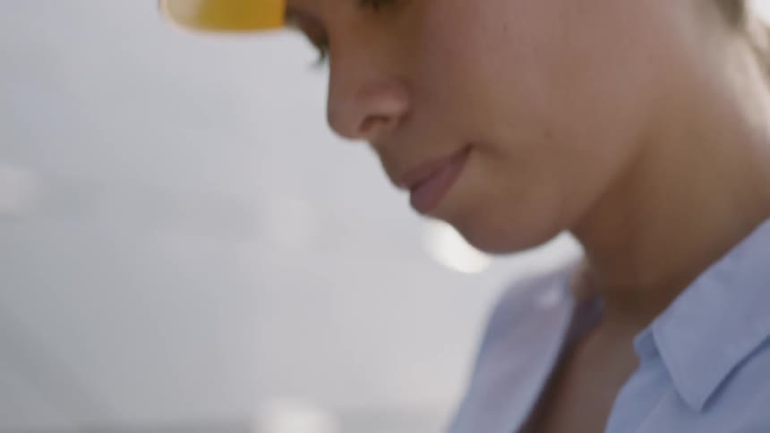 A black woman types on a laptop keyboard