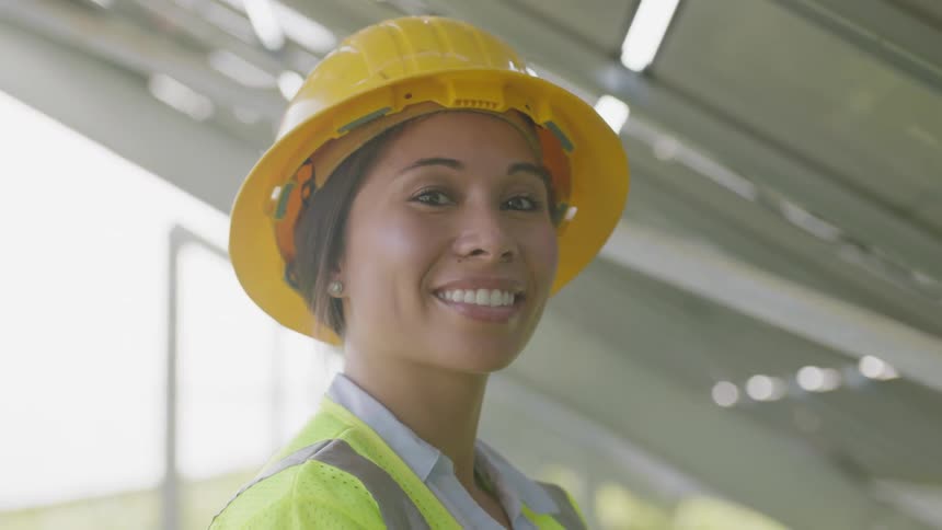 A woman inspecting items on solar panels