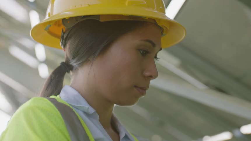 Female inspector typing in her laptop at a job site