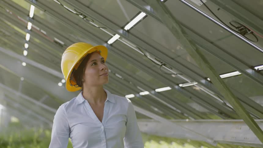 Woman examines panels from underneath