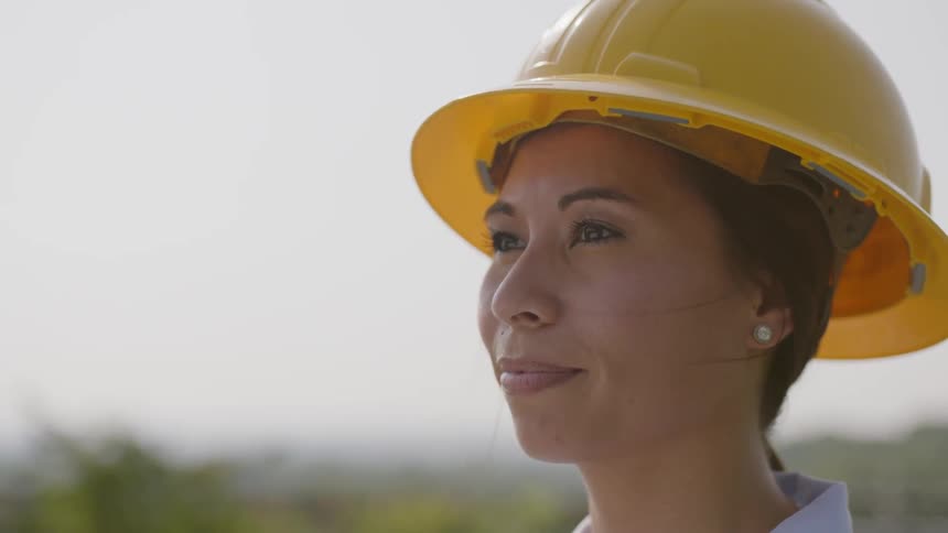 A woman puts on a hard hat