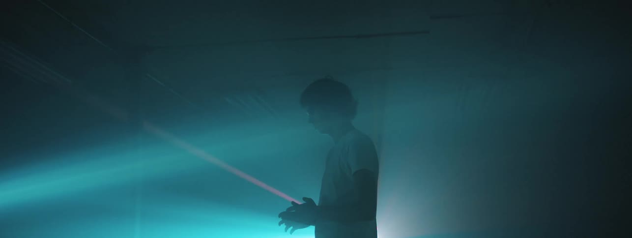 A young white man is scanned with a laser beam