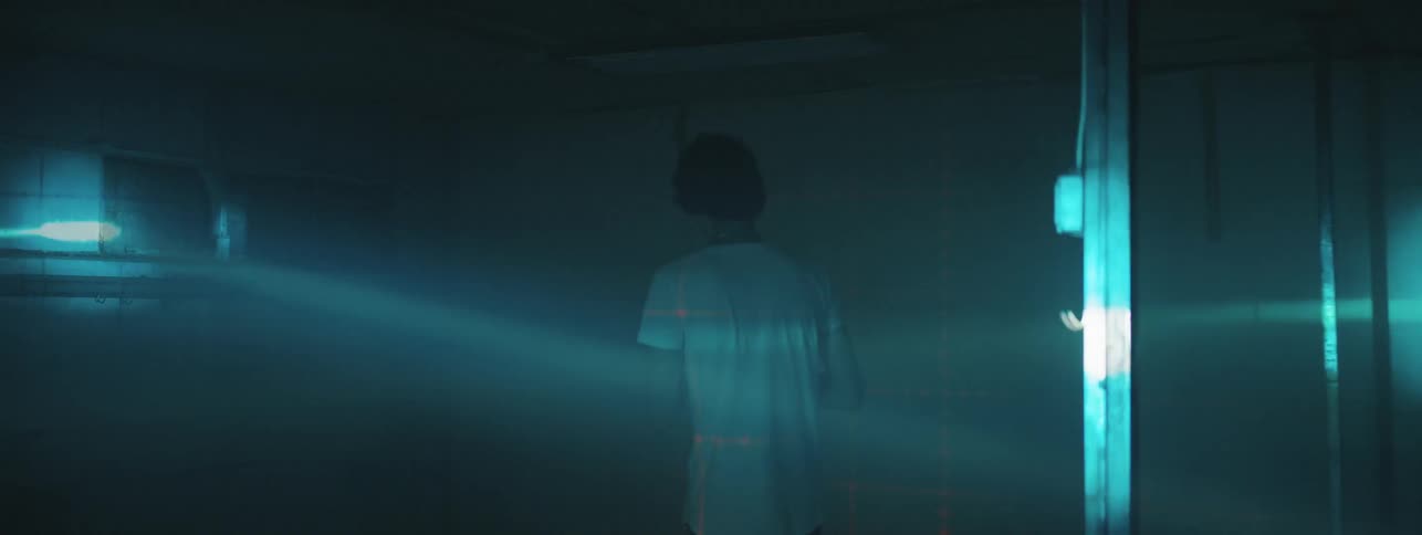 Teenage boy walks through dark room with strobe light
