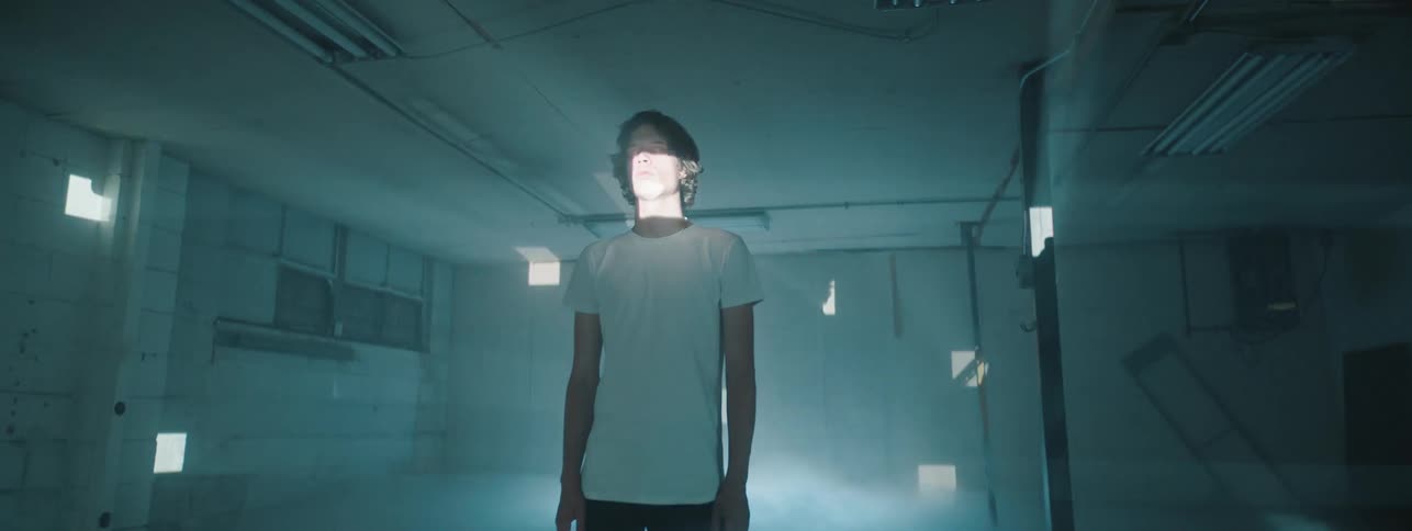 Man standing in a foggy room with multiple light sources