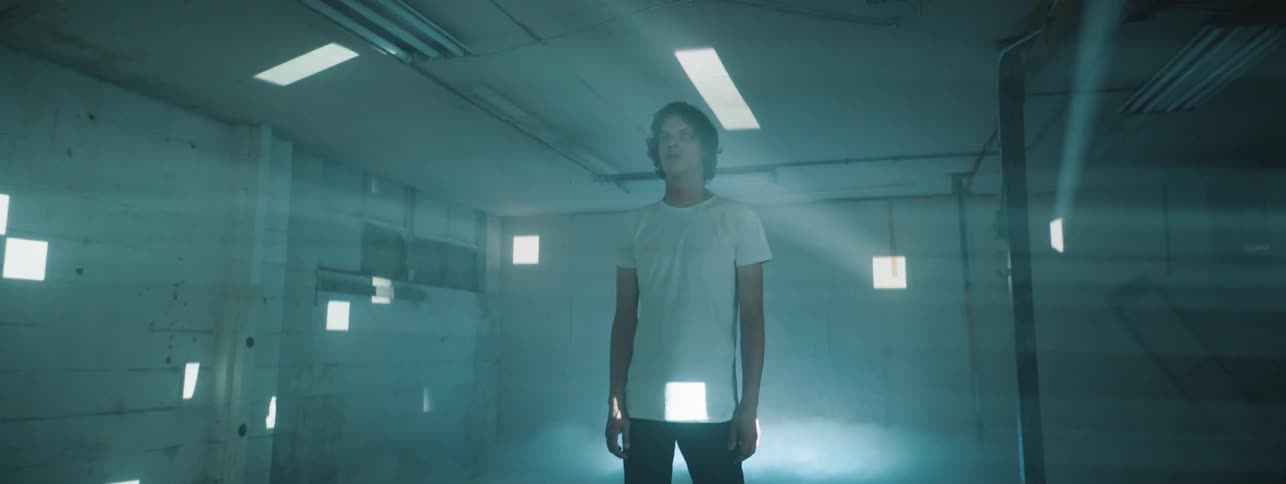 Man stands in room with smoke a flickering lights