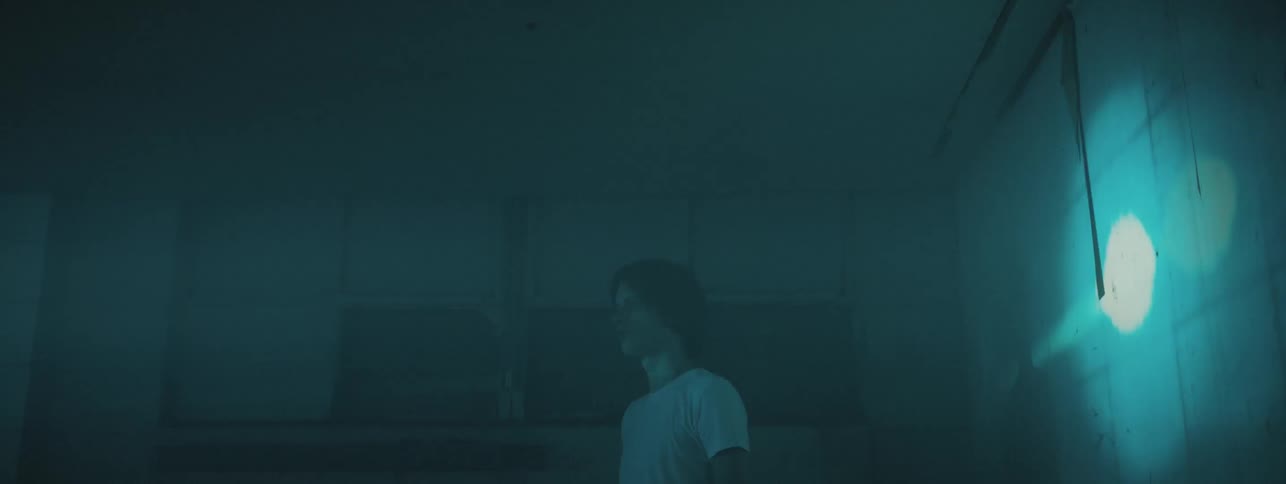 Man stands in room with strobing lights