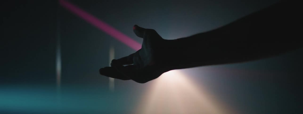Man holds his hand in the strobing lights