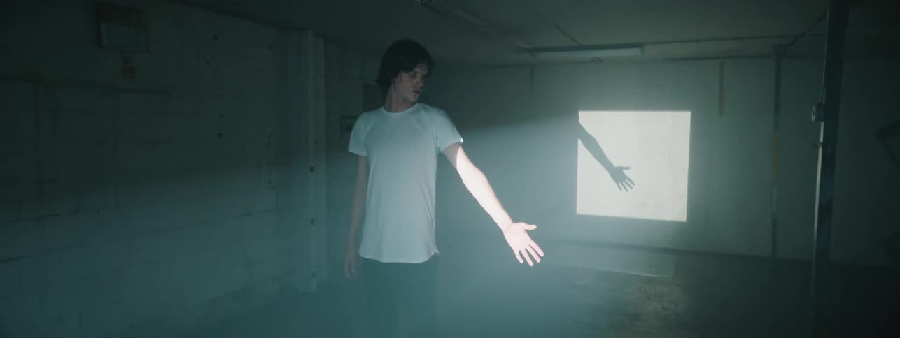 A person puts their hand into a beam of light
