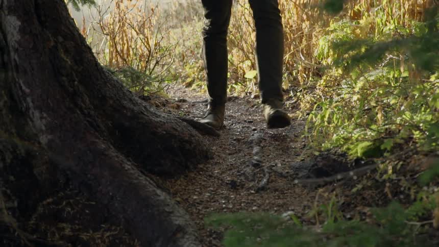 A woman is walking along a trail