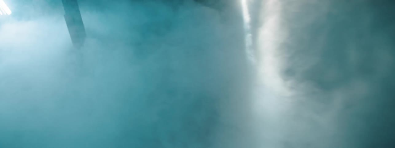 A light sweeping through a smoky room