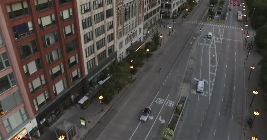 A busy city street illuminated at low sun as traffic moves