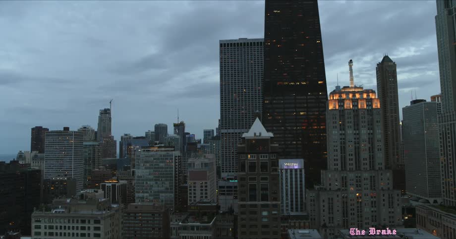 The city is full of tall buildings at sunset