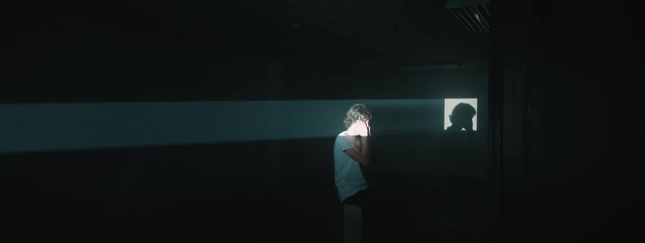 A projection light shines on a man
