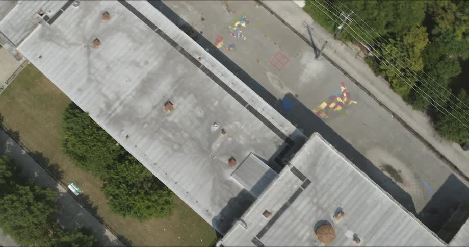 The vehicles are parked on the roads around the building