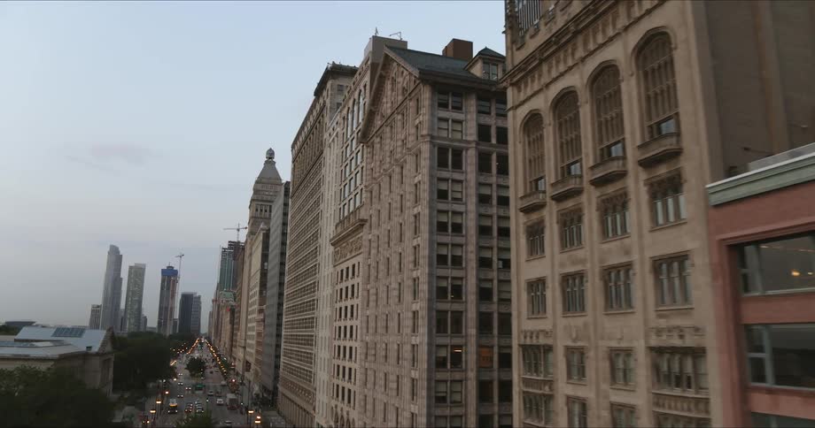 An aerial view of a long city street on an overcast day