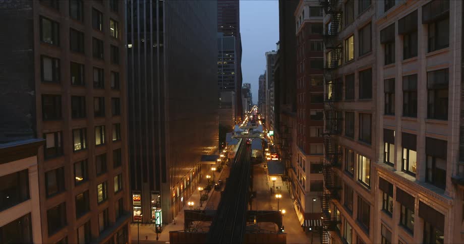 Flying over a city street with buildings on either side