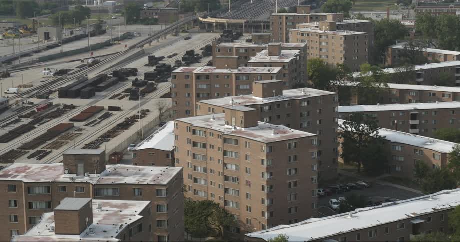 A housing complex sits next to railroad tracks