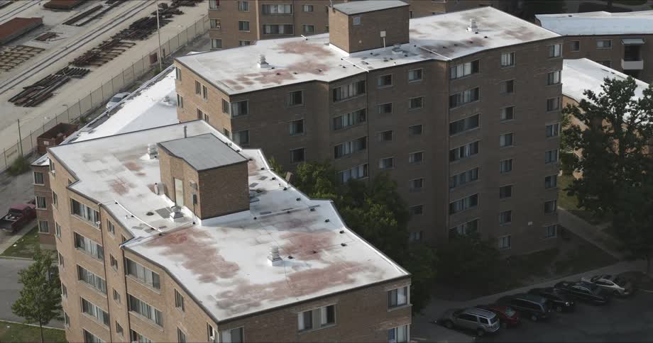 The camera flies over apartment buildings