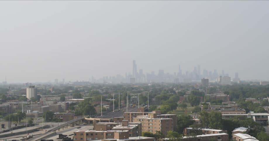 The highway leads to the city in the distance covered with fog