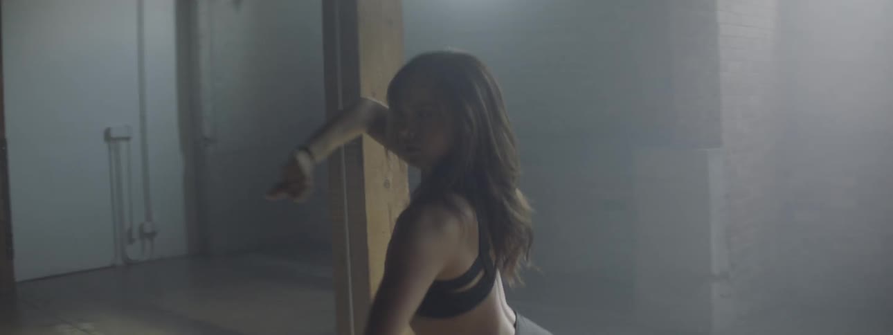 A woman dancing in a empty room