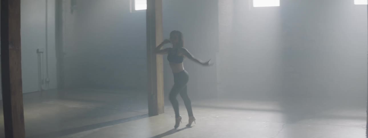 A woman dancing and twirling in a dance studio