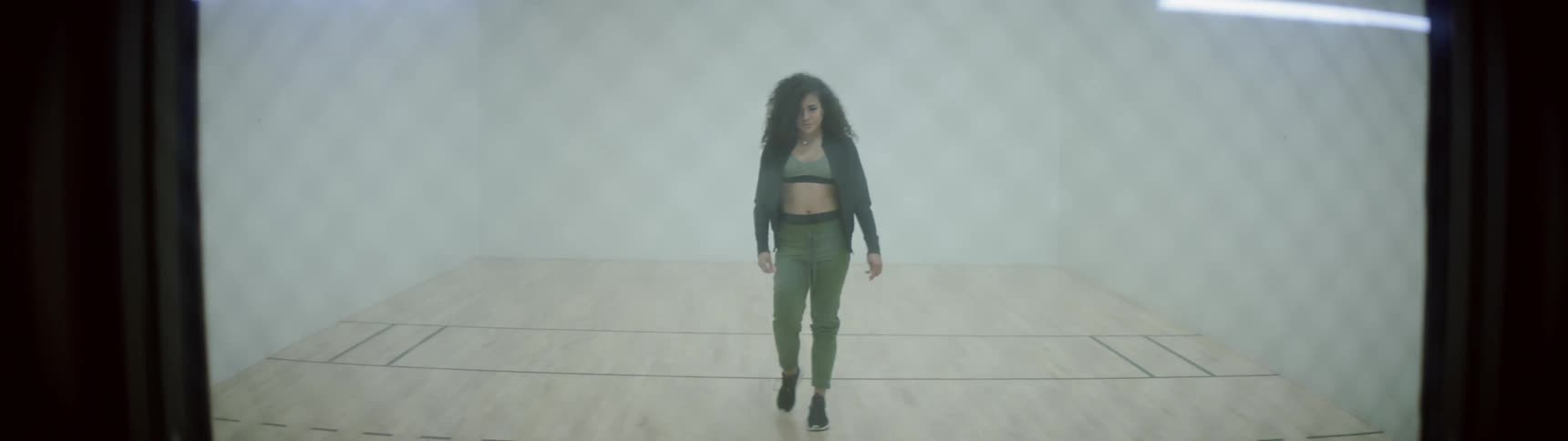 A woman walking in a small court