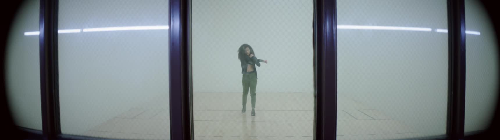 A woman is stretching and walking indoors