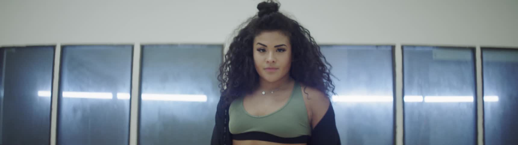 A woman shakes her head rapidly and dances