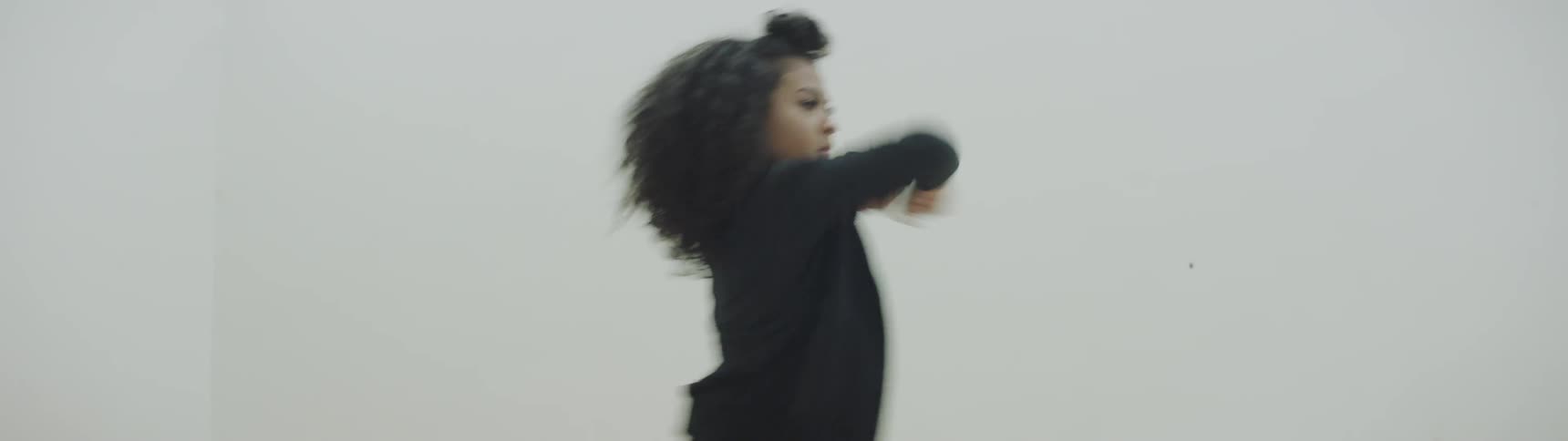 A woman is dancing in the bright hall