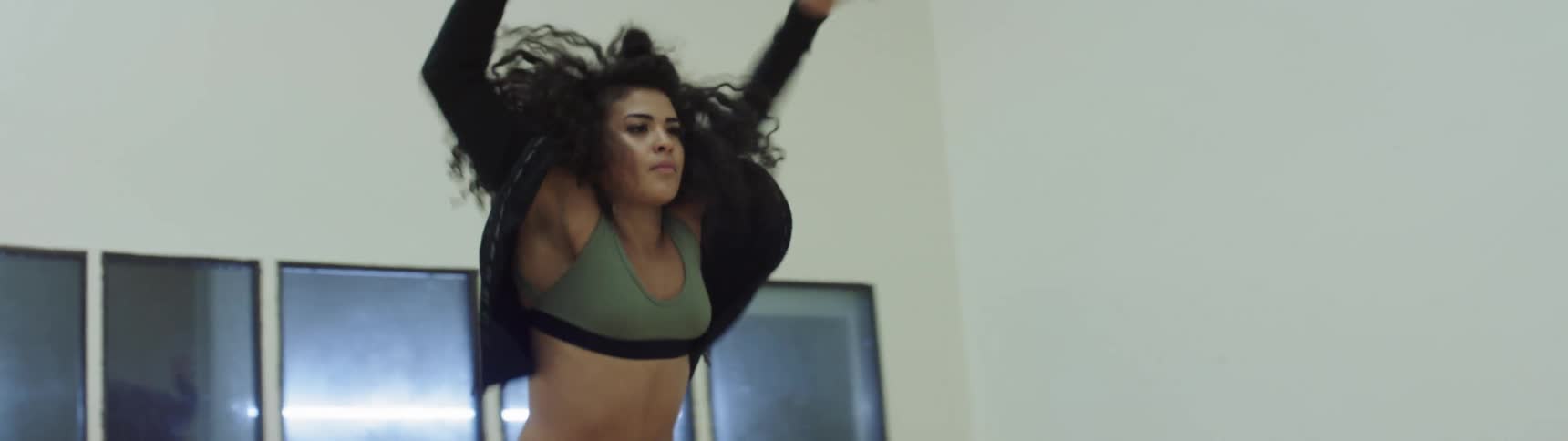 A woman is dancing indoors