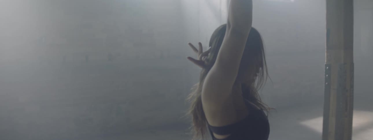 Woman dances in a basement studio