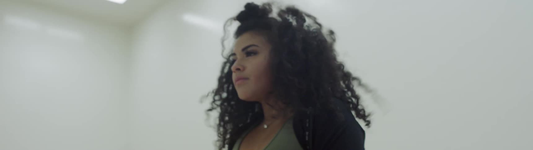 A woman dancing in an empty room